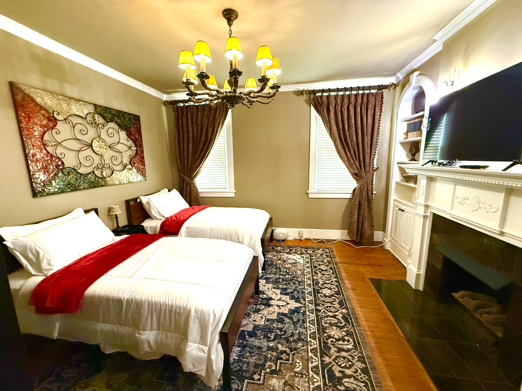A spacious shared bedroom with two beds and warm lighting